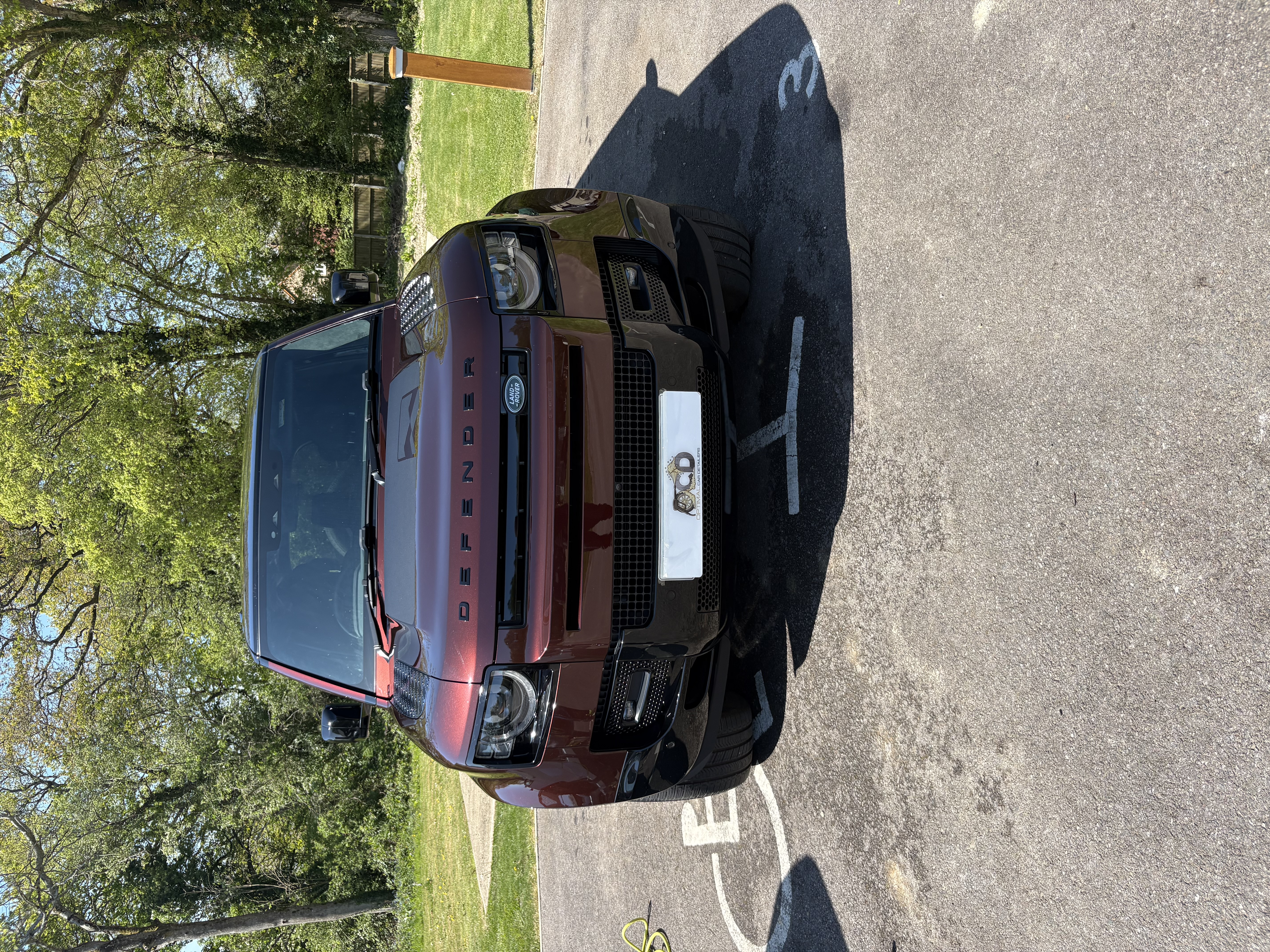 Burgundy Land Rover Defender — front after deep decontamination